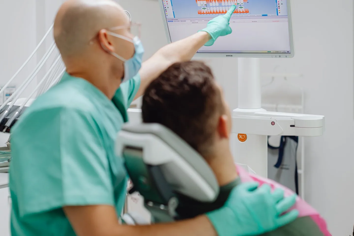 Dentist and patient reviewing a digital dental image together in a clinic